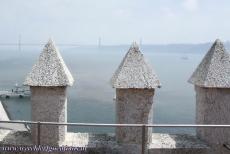 Tower of Belém - The 25 de Abril Bridge viewed from the Tower of Belém, a 16th century tower in Lisbon, built on a small island in the Tagus...