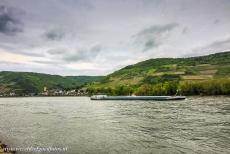 Upper Middle Rhine Valley - Upper Middle Rhine Valley: A cargo boat on Rhine close to Lorch am Rhein, once the capital city of the former Free State Bottleneck. For two...