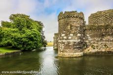Castles of King Edward in Gwynedd - The Castles and Town Walls of King Edward in Gwynedd: The outer curtain wall and the moat of Beaumaris Castle. The castle has two gates, the...