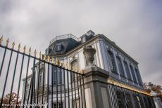 Falkenlust Castle in Brühl - Castles of Augustusburg and Falkenlust at Brühl: Falkenlust Castle is surrounded by a wrought iron fence, decorated with golden...