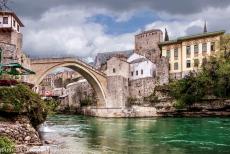 Old Bridge Area of the Old City of Mostar - Old Bridge Area of the Old City of Mostar: The green-tinted waters of the Neretva flow beneath the Old Bridge of Mostar, the Stari Most. The...