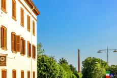 Crespi d'Adda - The chimney of the cotton factory is towering high above the workers' village of Crespi d'Adda. The village was built to a geometric...