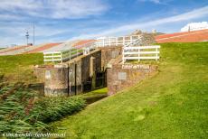 Dutch part of the Wadden Sea - An old sluice gate between the Ommelander Sea Dike and the Wadden Sea at Noordpolderzijl. Along the shallow Wadden Sea, the...