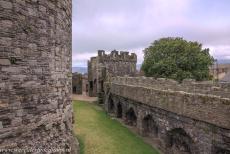 Beaumaris Castle - Castles and Town Walls of the King Edward in Gwynedd: The Gate Next the Sea, the outer wall and moat of Beaumaris Castle viewed from the castle...