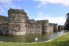 Beaumaris Castle - Castles and Town Walls of King Edward in Gwynedd: The outer wall and the moat of Beaumaris Castle. Four lines of massive fortifications...