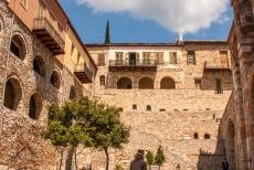 Monastery of Hosios Loukas - A Greek Orthodox monk on his way to the Katholikon of the Monastery of Hosios Loukas. On the left hand side the cells of the monks. Greek...