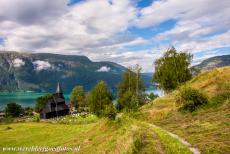 Urnes Stave Church - The Urnes Stave Church, in the background the Lustrafjord. The wooden church is surrounded by the breathtaking nature of Norway The...