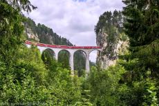 Rhaetian Railway, the Albula and Bernina Lines - Rhaetian Railway in the Albula / Bernina Landscapes: A train on the Landwasser Viaduct outside Filisur. The Landwasser Viaduct is the most...