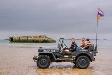 Beaches of the D-Day landings, Normandy, 1944 - Beaches of the D-Day landings, Normandy: A 1942 Ford GPW RAF Jeep on Gold Beach at Arromanches-les-Bains, with the remains of the Mulberry Harbour... Beaches of the D-Day landings, Normandy, 1944 - Beaches of the D-Day landings, Normandy: A 1942 Ford GPW RAF Jeep on Gold Beach at Arromanches-les-Bains, with the remains of the Mulberry Harbour...