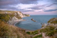 Dorset and East Devon Coast - The Dorset and East Devon Coast: The Man O' War Cove at sunset, viewed from the South West Coast Path. The Man O' War Cove is a small... Dorset and East Devon Coast - The Dorset and East Devon Coast: The Man O' War Cove at sunset, viewed from the South West Coast Path. The Man O' War Cove is a small...