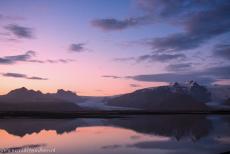 Vatnajökull National Park - Vatnajökull National Park - dynamic nature of fire and ice: The evening sky at twilight reflected in the glacial lake...